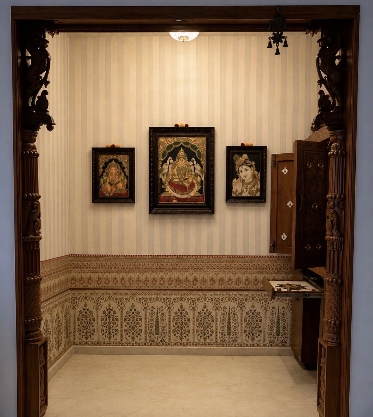 The Tanjore paintings on the wall, against the wallpaper the stylist suggested