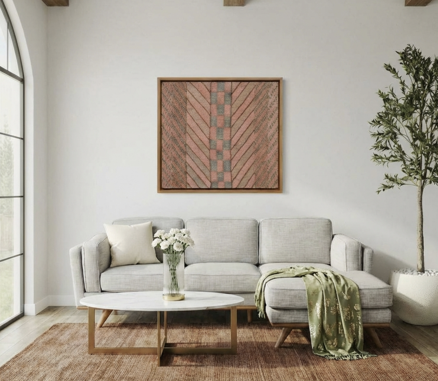 A grey sofa under a single large framed textile artwork, the one piece anchoring an otherwise clean wall