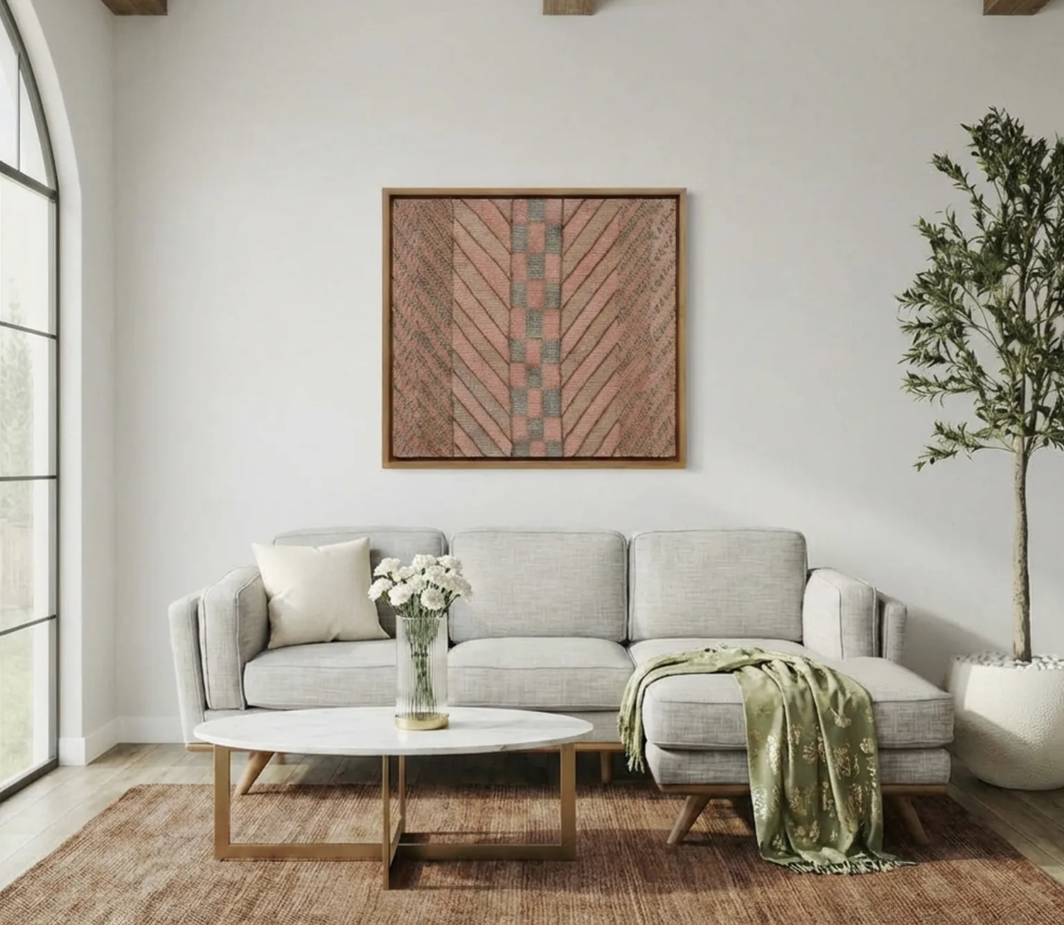 A grey sofa under a single large framed textile artwork, the one piece anchoring an otherwise clean wall